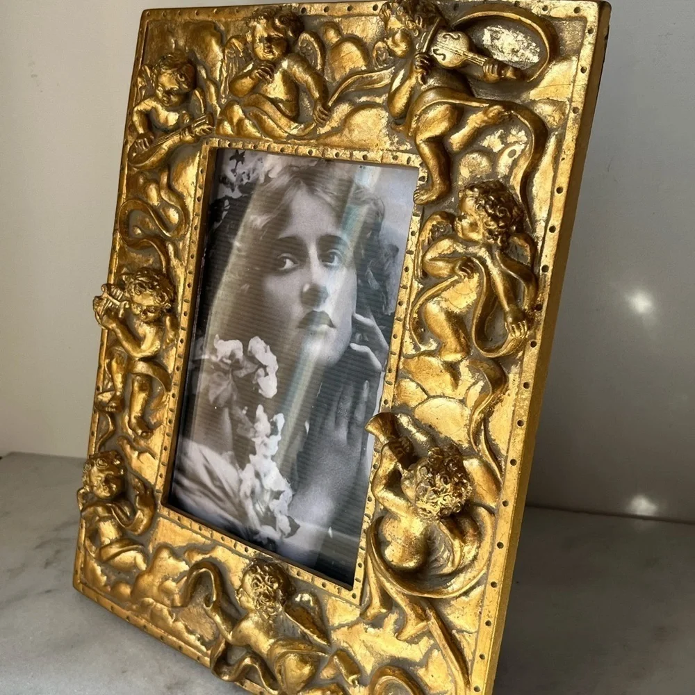 Large gilded Cherub Picture Frame holds 5”x7”. Rare